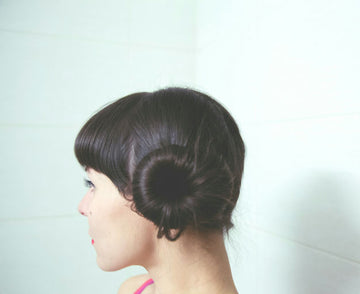 Woman using a hair straightener with sleek, straight hair to demonstrate the perfect styling tool choices