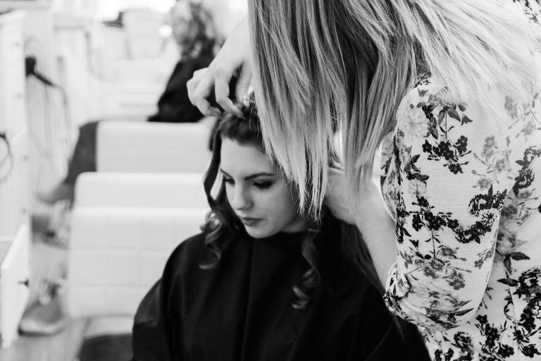 Main image of blog article showing a variety of high-quality hair straighteners on a wooden countertop, ideal for different hair types and styling needs