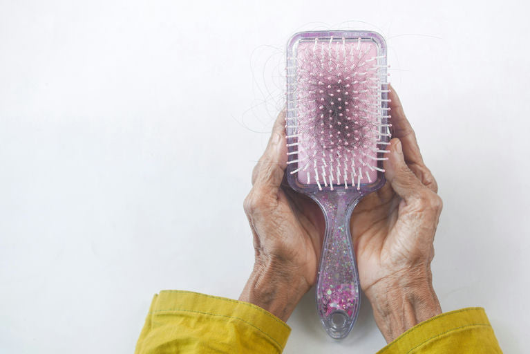 Woman mastering hair care by wisely using hair straightener and curler at home